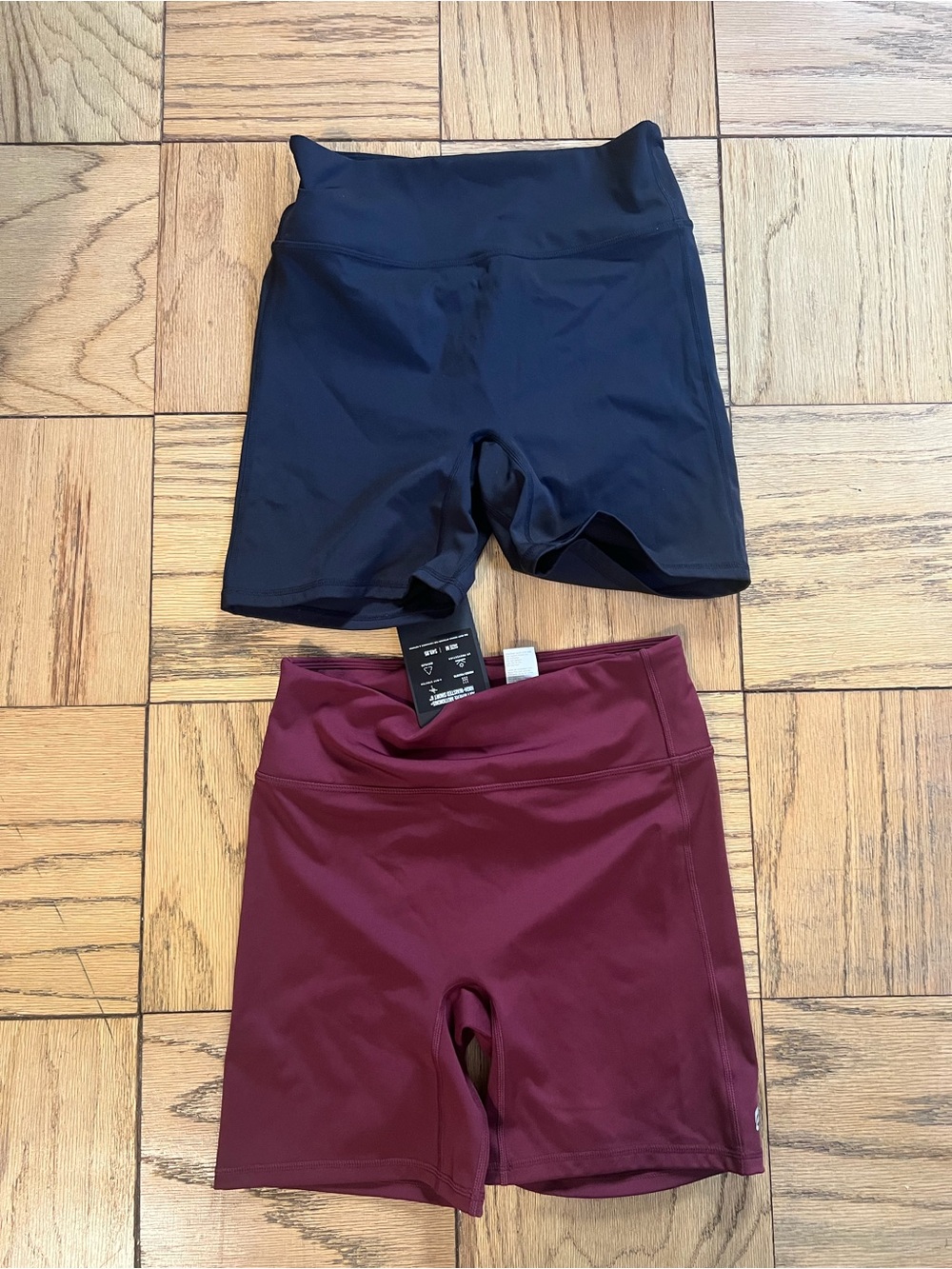 Fabletics Women's High-Rise Bike Shorts in Black and Burgundy
